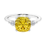 Cushion shaped engagement ring with brilliant diamonds and yellow sapphire.
