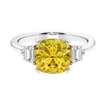 Cushion shaped engagement ring with brilliant diamonds and yellow gemstone.
