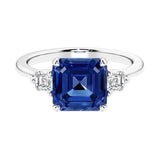 Asscher gemstone diamond ring with step-cut sparkle in a three stone setting.