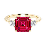 Asscher cut three stone engagement ring with geometric elegance.