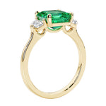 3 stone Asscher cut gemstone diamond ring in a classic Art Deco style featuring a colombian emerald center.