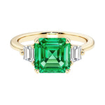 Asscher cut three stone engagement ring with geometric elegance.