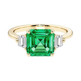 Asscher cut three stone engagement ring with geometric elegance.