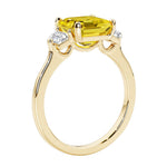 3 stone Asscher cut gemstone diamond ring in a classic Art Deco style featuring a yellow sapphire center.