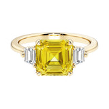 Asscher cut three stone engagement ring with geometric elegance.