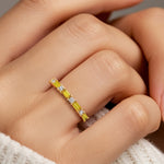 Nine stone anniversary diamond ring for women with vibrant gemstones and white diamonds.