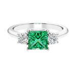 3 stone princess diamond ring in sleek white gold with colombian emerald gemstone.