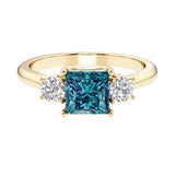 Princess cut 3 stone engagement ring with side diamonds and alexandrite gemstone center.