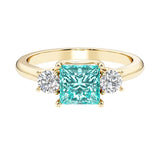 Princess cut 3 stone engagement ring with side diamonds and paraiba tourmaline gemstone center.
