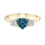 Heart shaped 3 stone engagement ring with elegant diamond side stones.