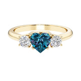 Heart shaped 3 stone engagement ring with elegant diamond side stones.