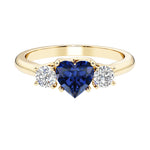 Heart shaped 3 stone engagement ring with elegant diamond side stones.