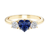 Heart shaped 3 stone engagement ring with elegant diamond side stones.