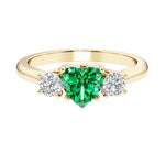 Heart shaped 3 stone engagement ring with elegant diamond side stones.