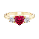 Heart shaped 3 stone engagement ring with elegant diamond side stones.
