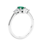 Marquise shaped engagement ring with diamonds in classic 3 stone ring setting.