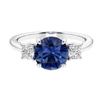 Timeless three stone round diamond engagement ring.