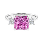 3 stone princess diamond ring in sleek white gold with pink sapphire gemstone center.