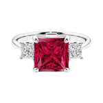 3 stone princess diamond ring in sleek white gold with ruby gemstone center.