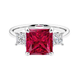 3 stone princess diamond ring in sleek white gold with ruby gemstone center.