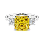 3 stone princess diamond ring in sleek white gold with yellow sapphire gemstone center.