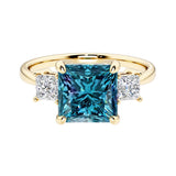 Princess cut 3 stone engagement ring with square side diamonds and alexandrite gemstone center.