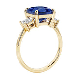 Elegant three stone princess cut engagement ring with blue sapphire and diamonds.