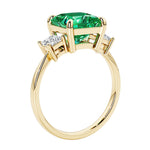 Elegant three stone princess cut engagement ring with colombian emerald and diamonds.