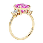 Elegant three stone princess cut engagement ring with pink sapphire and diamonds.