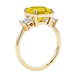 Elegant three stone princess cut engagement ring with yellow sapphire and diamonds.