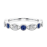 Elegant vintage-inspired anniversary ring featuring marquise blue sapphires and diamonds in a 9 stone setting.