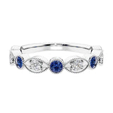 Elegant vintage-inspired anniversary ring featuring marquise blue sapphires and diamonds in a 9 stone setting.