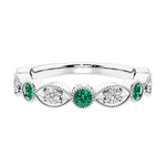 Elegant vintage-inspired anniversary ring featuring marquise green emeralds and diamonds in a 9 stone setting.