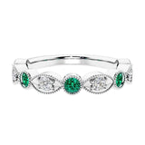 Elegant vintage-inspired anniversary ring featuring marquise green emeralds and diamonds in a 9 stone setting.