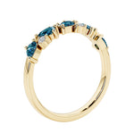 Unique 9 stone half eternity ring with pear shaped Alexandrite and round diamond accents in yellow gold.