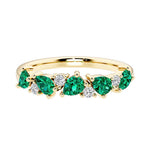 9-stone gemstone anniversary band featuring pear-cut green emeralds and round diamonds for a magical, color-shifting effect.