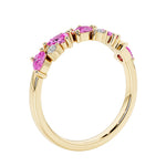 Unique 9 stone half eternity ring with pear shaped pink sapphire and round diamond accents in yellow gold.