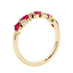Unique 9 stone half eternity ring with pear shaped ruby and round diamond accents in yellow gold.