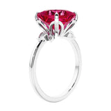 Women's unique ring with lab created ruby and sparkling round diamonds in a vintage-inspired cluster side stone style.