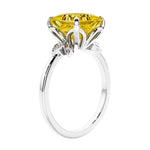 Women's unique ring with lab created yellow sapphire and sparkling round diamonds in a vintage-inspired cluster side stone style.