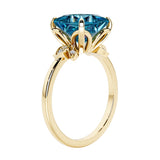 Unique nature inspired ring with princess cut Alexandrite and round diamond accents in yellow gold.