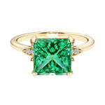 Nature inspired ring featuring princess cut green emeralds and round diamonds for a magical, color-shifting effect.