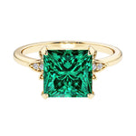 Nature inspired ring featuring princess cut green emeralds and round diamonds for a magical, color-shifting effect.
