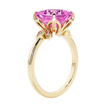 Unique nature inspired ring with princess cut pink sapphire and round diamond accents in yellow gold.