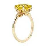 Unique nature inspired ring with princess cut yellow sapphire and round diamond accents in yellow gold.