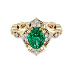 Oval cut vintage emerald and diamond ring in yellow gold