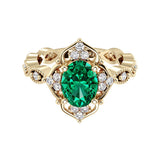 Oval cut vintage emerald and diamond ring in yellow gold