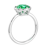 Oval Colombian emerald solitaire bezel ring in 14K white gold with tapered band by Pel & Co – luxury emerald engagement ring