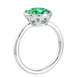 Oval Colombian emerald solitaire bezel ring in 14K white gold with tapered band by Pel & Co – luxury emerald engagement ring