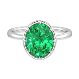 Pel & Co oval Colombian emerald solitaire ring in white gold bezel setting with tapered band – vivid green emerald engagement ring